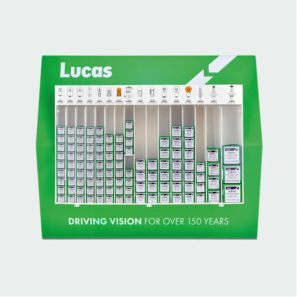 A Lucas automotive bulb display stand containing multiple boxed vehicle bulbs arranged by type, with Lucas branding and product identification labels.