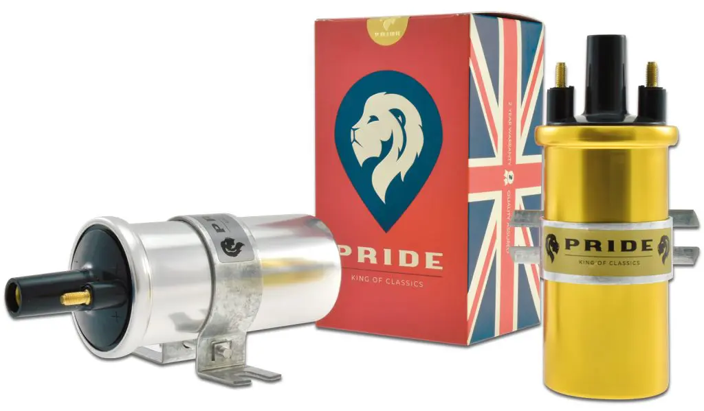 Two ignition coils next to a box featuring a Union Jack design and a blue emblem with a white lion's head. One coil is silver and the other is gold, both with black and gold connectors and mounting brackets.
