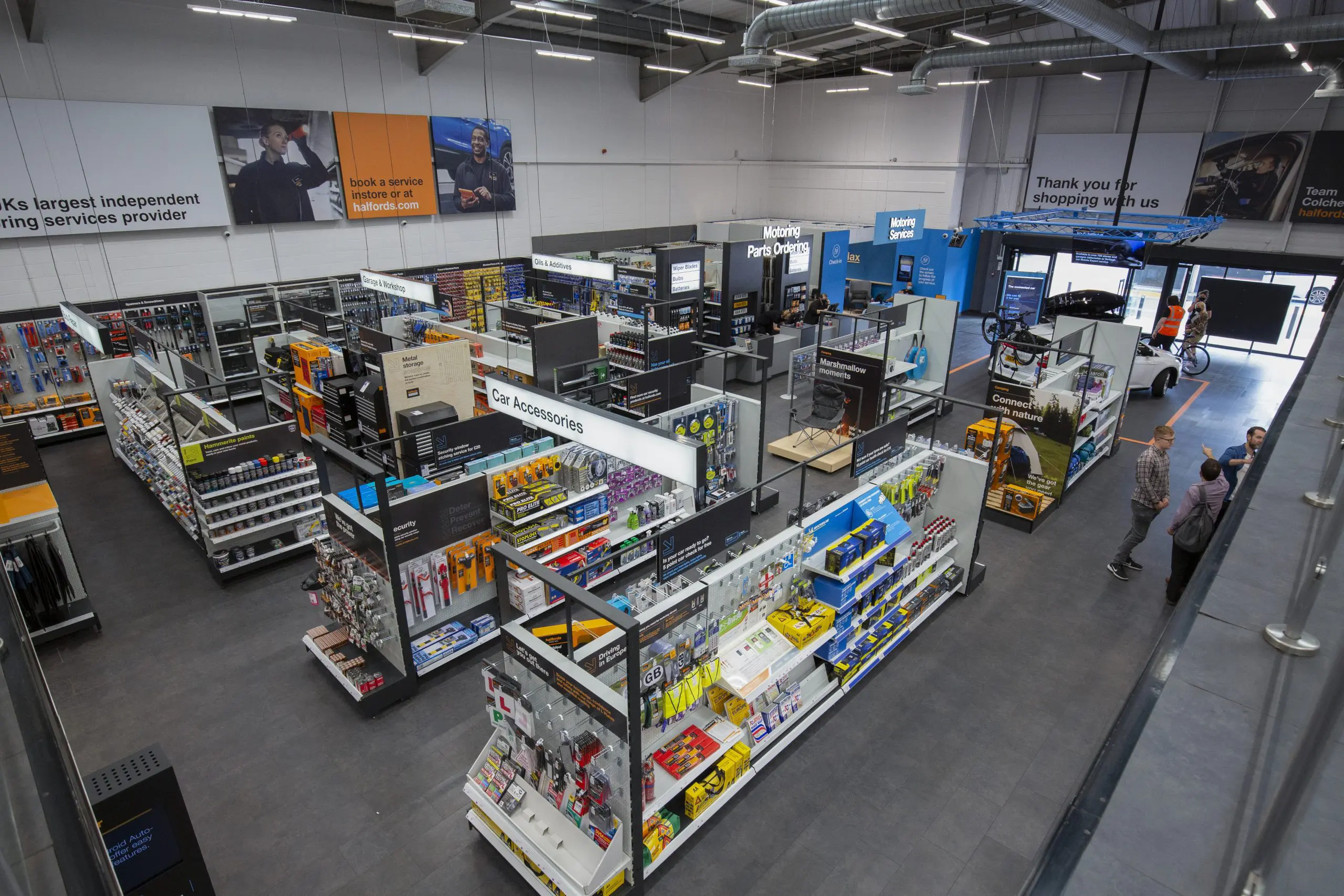An aerial view on the inside of a Halford's store, shelves full of automotive parts and accessories.