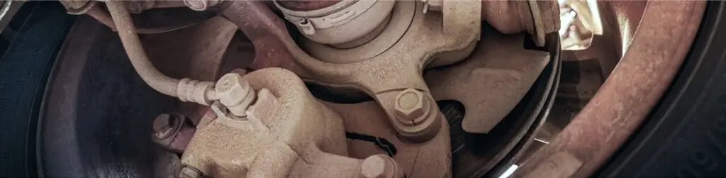 Close-up view of a vehicle suspension and steering assembly.