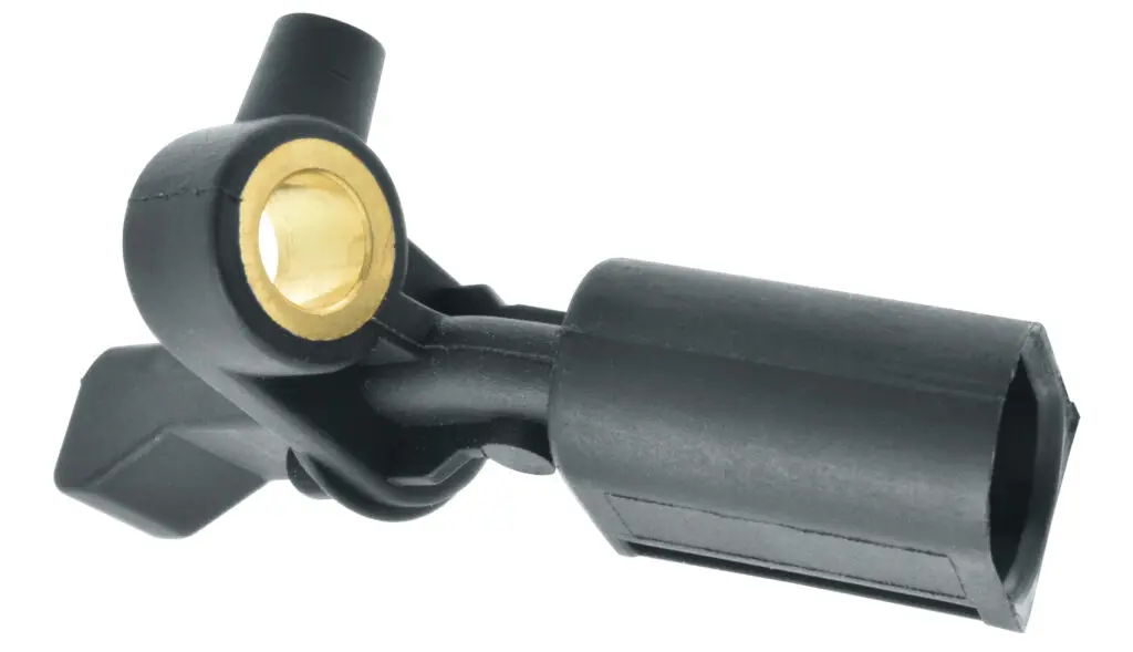 A Wheel Speed Sensor on a white background. It is black plastic with a brass nut. 