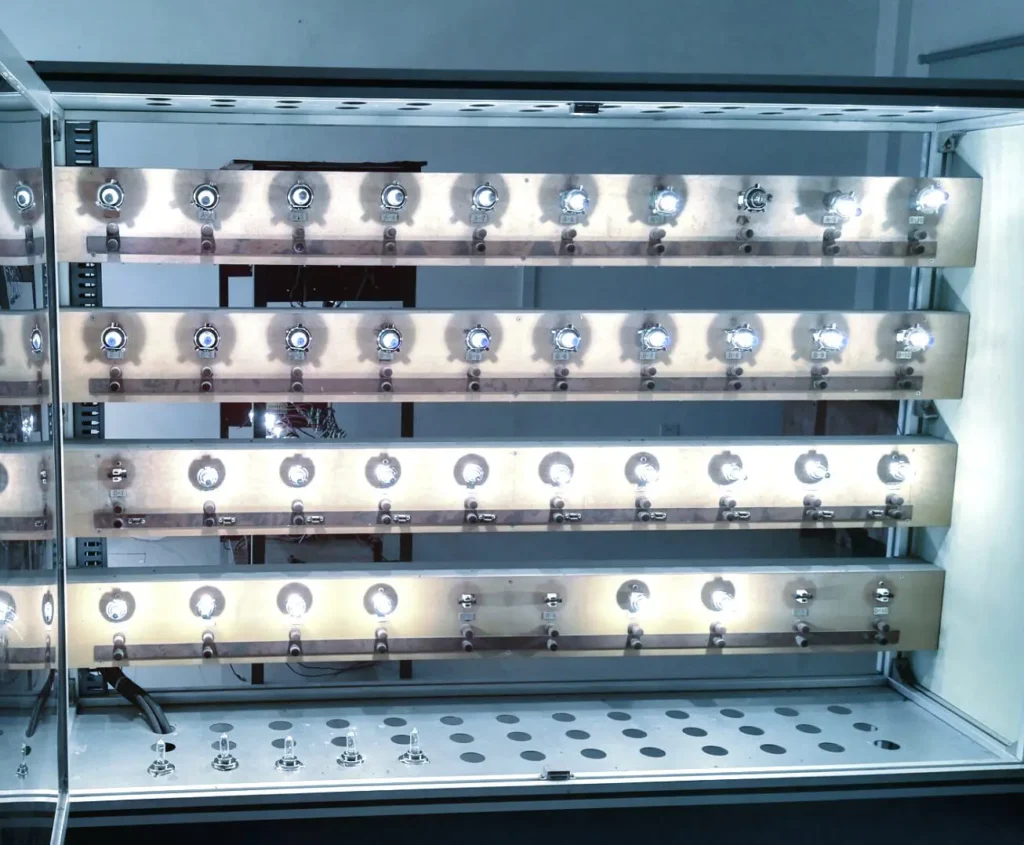 A series of automotive bulbs inside a testing rack. 